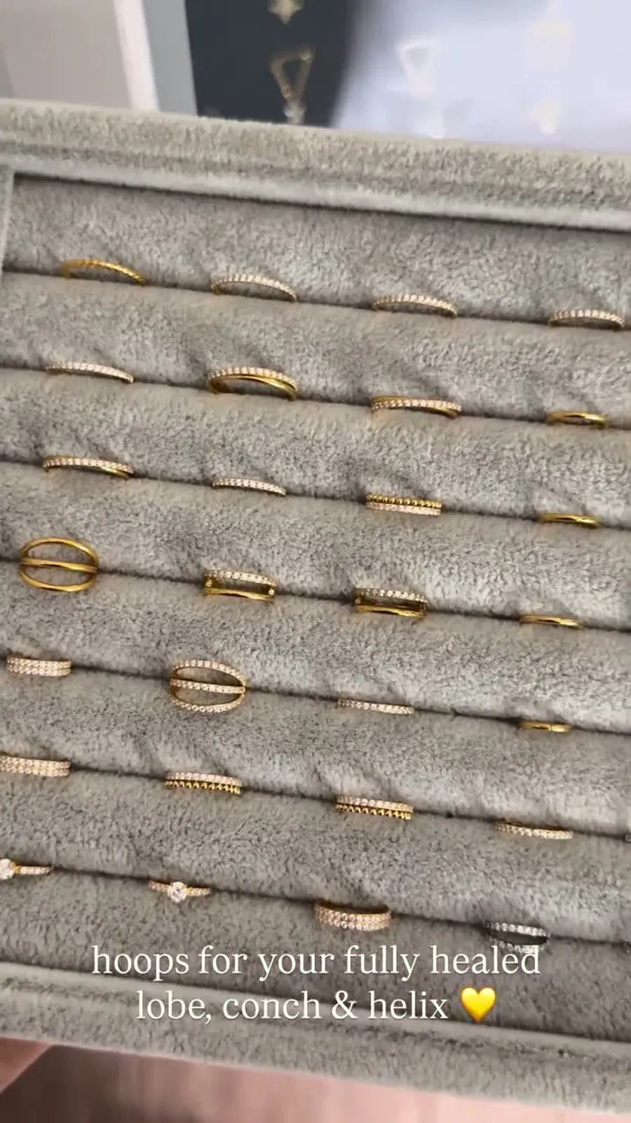 Velvet tray of gold and silver hoop earrings for healed lobe, conch, and helix piercings
